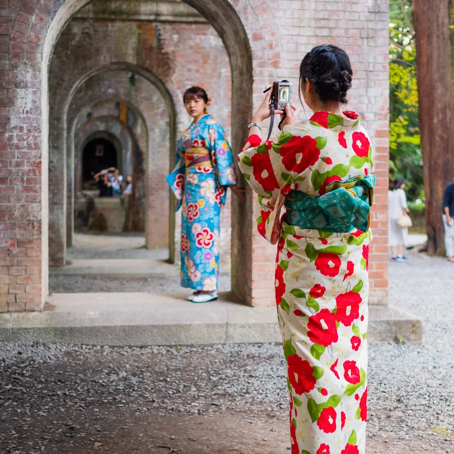 Travelers in rented kimono on a Kyoto lane